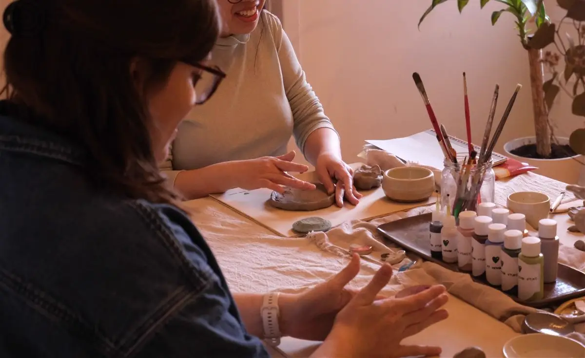 Guests shaping clay during a pottery session